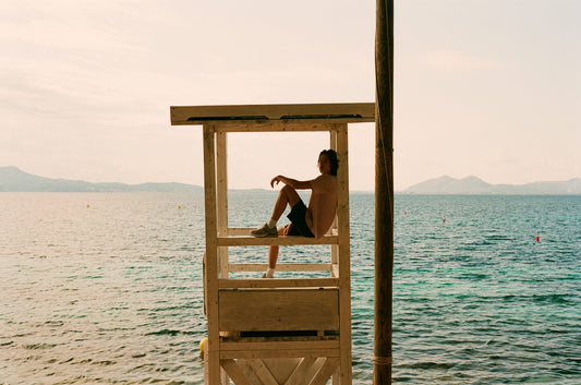 Sepia toned image of model sitting in the sea