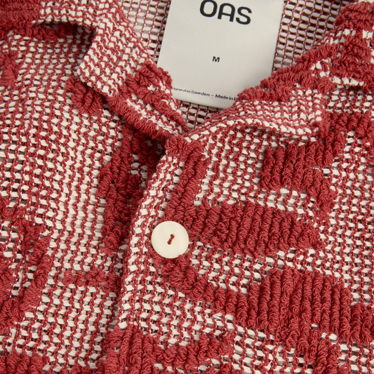 Red and white textured fabric with a button and 'GAS' brand tag.
