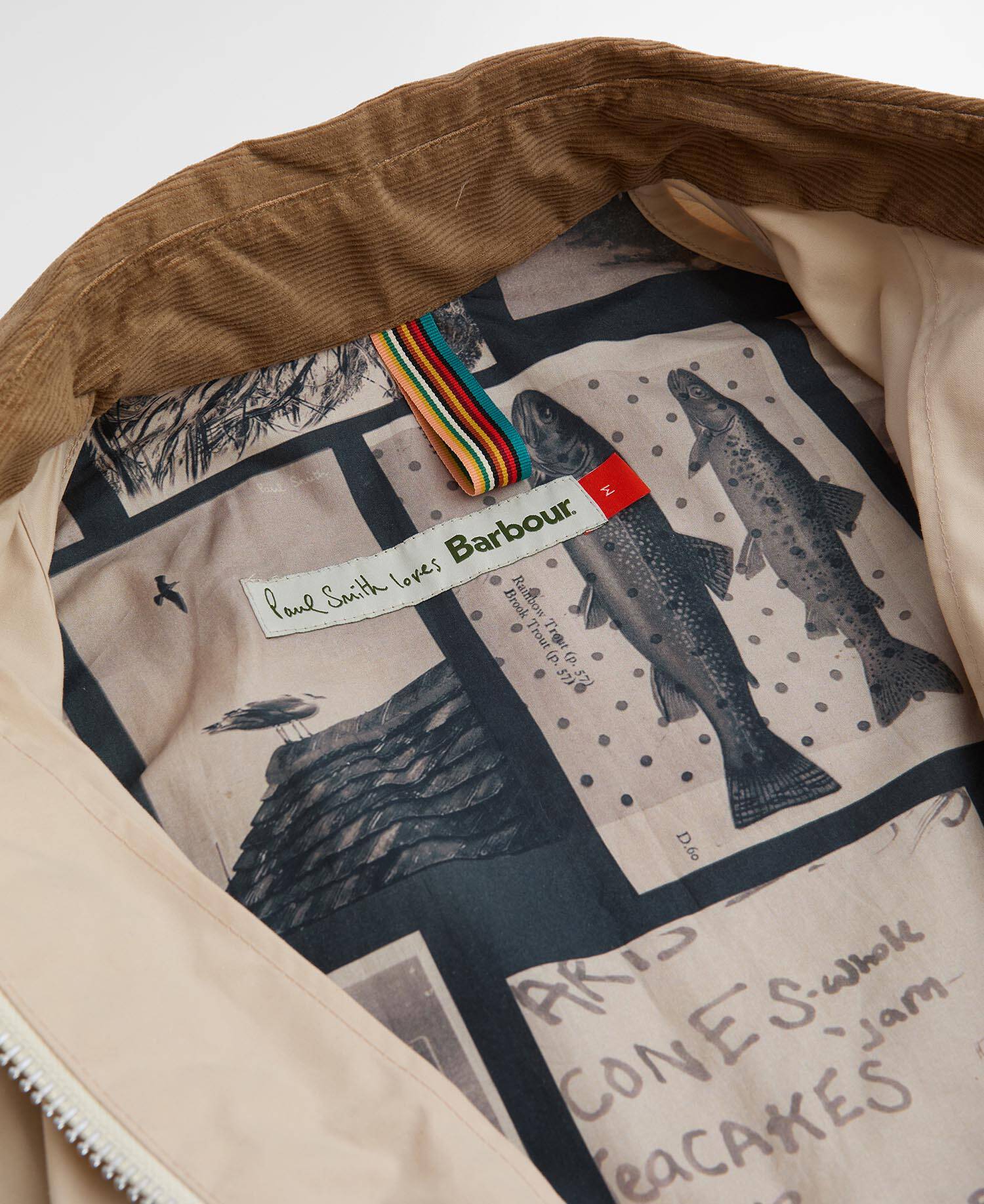 Close-up of a Barbour jacket interior with a patterned lining and brand label.