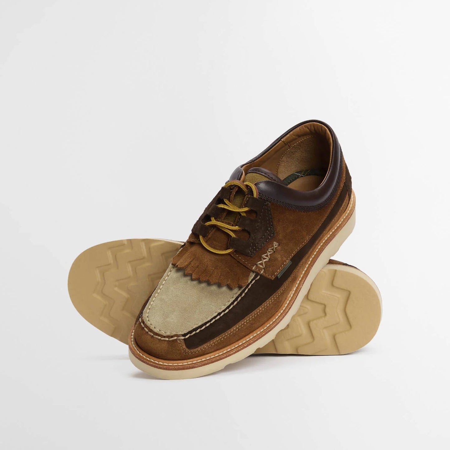 Brown and beige boat shoe on a white background